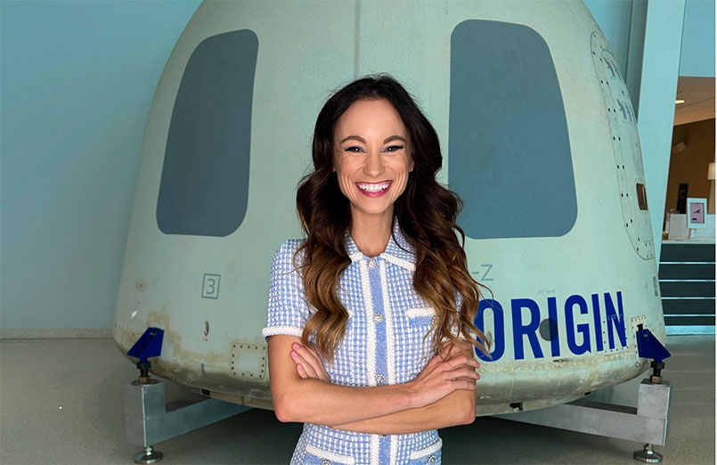 Emily Calandrelli in front of Blue Origin capsule